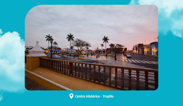 Centro Histórico Trujillo plaza at dusk with palm trees, colonial buildings, wet pavement, people and taxis in Peruvian centre