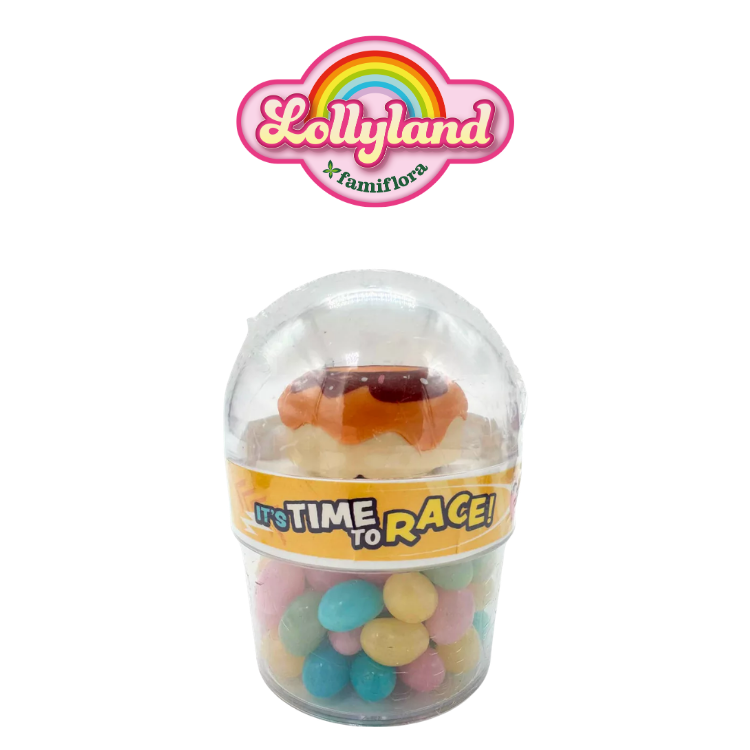 Lollyland clear plastic capsule filled with pastel candy eggs and a toy donut under a domed lid, yellow "It's Time to Race!" band