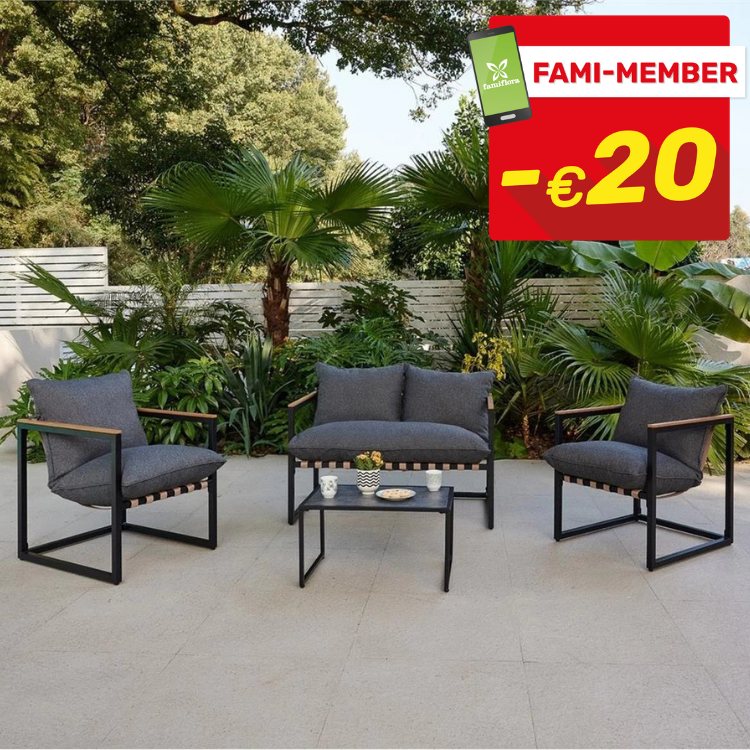 Grey-cushioned outdoor patio set with black frames and coffee table on tiled terrace, garden backdrop and red €20 FAMI-MEMBER badge