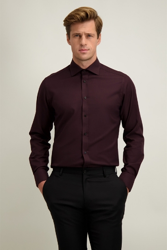 Male model wearing a slim-fit burgundy dress shirt and black trousers, standing with hands in pockets against a plain background
