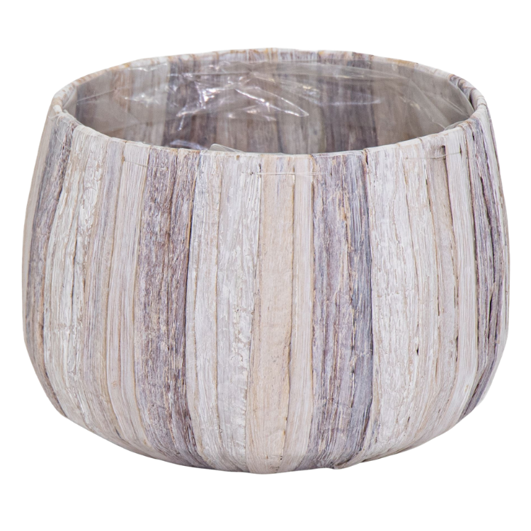Round greywashed wooden plant pot with vertical slats and clear plastic liner, rustic indoor planter