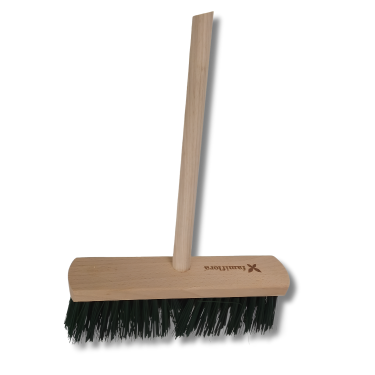 Wooden push broom with beech handle and dark green bristles on a rectangular wooden block against a white background
