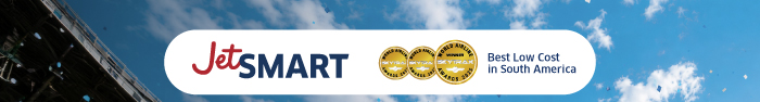 JetSMART logo with two gold award medals and text 'Best Low Cost in South America' over a blue sky with clouds