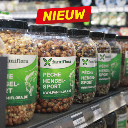 Fishing tackle store display of packaged bait, lures, hooks, lines and nets on shelves with 'Nieuw' new-product signs