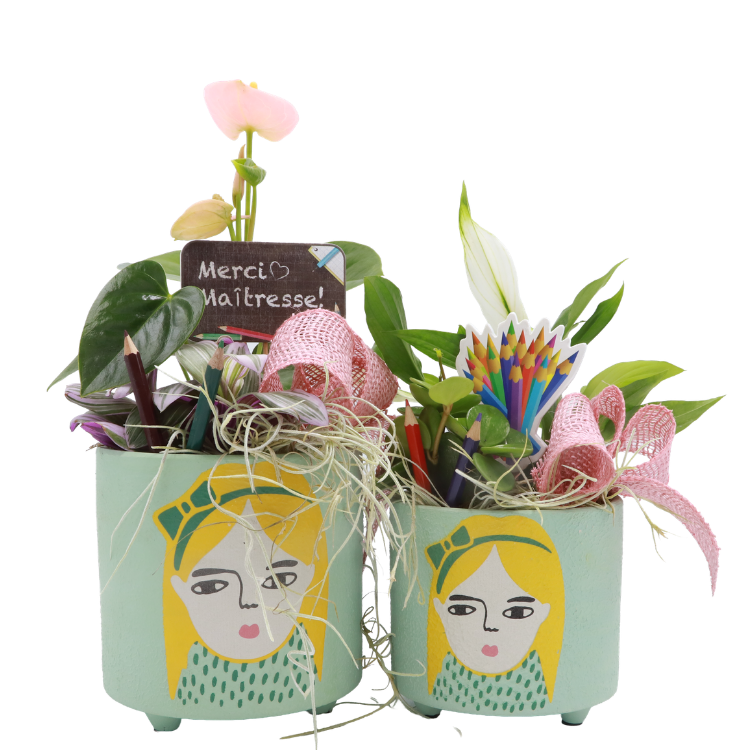 Two mint teacher pots painted with girl faces, with plants, pencils, pink ribbons and chalkboard 'Merci Maîtresse'