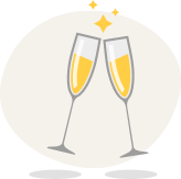 Two clinking champagne flutes with golden bubbles and sparkles