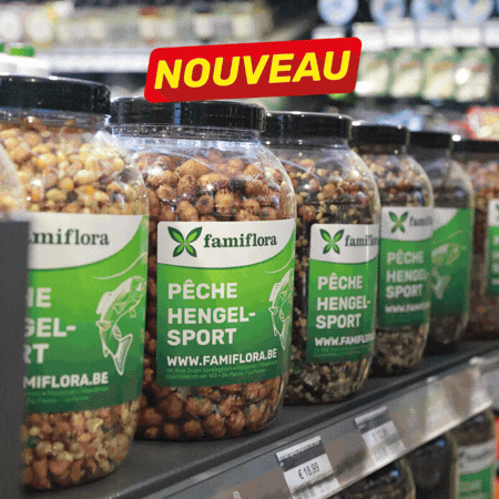 Store shelf display of fishing tackle and bait: jars, packaged lures, hooks, nets and price tags, many items labelled 'NOUVEAU'