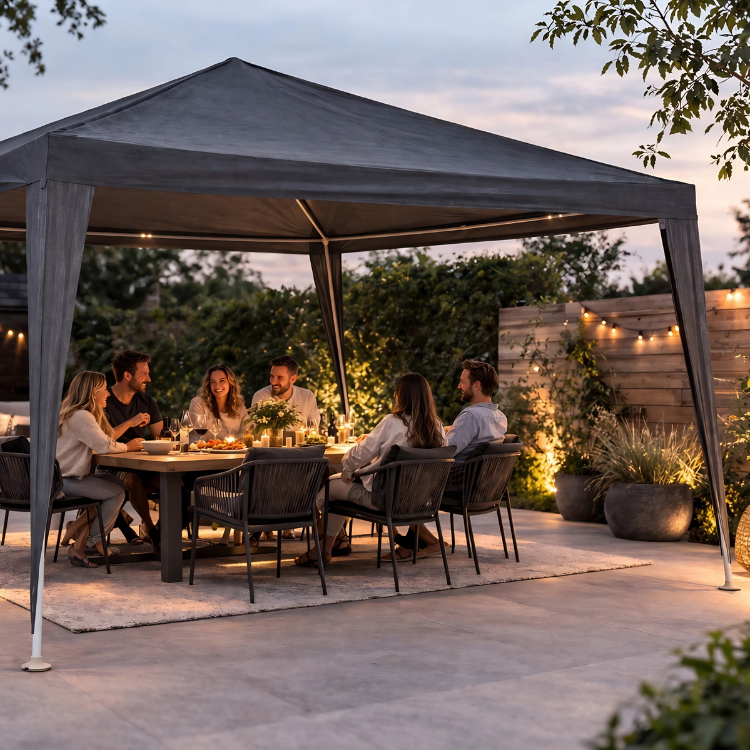 Six friends enjoying an outdoor dinner under a gazebo at dusk with candles and string lights in a cosy garden setting