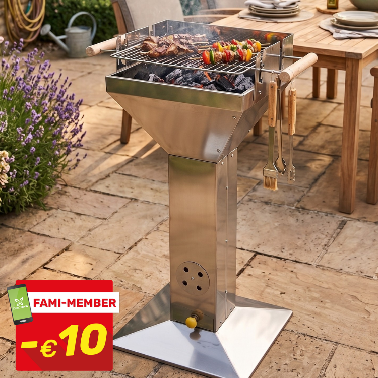 Stainless-steel pedestal charcoal barbecue with skewers and steaks grilling, utensils hanging beside patio dining