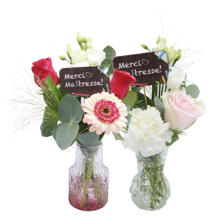 Two small glass vases with mixed flowers (pink rose, red rose, gerbera, white carnation, eucalyptus) and chalkboard signs reading 'Merci Maîtresse!'