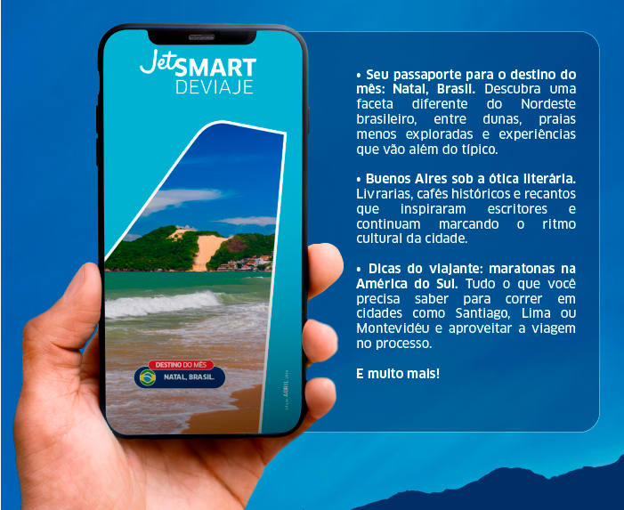 Hand holding smartphone showing JetSMART Deviaje travel promo for Natal, Brazil with beach photo and Portuguese destination