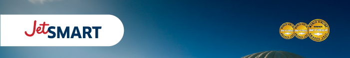 JetSMART airline logo against a blue sky with three gold award medals and a hot‑air balloon at lower right