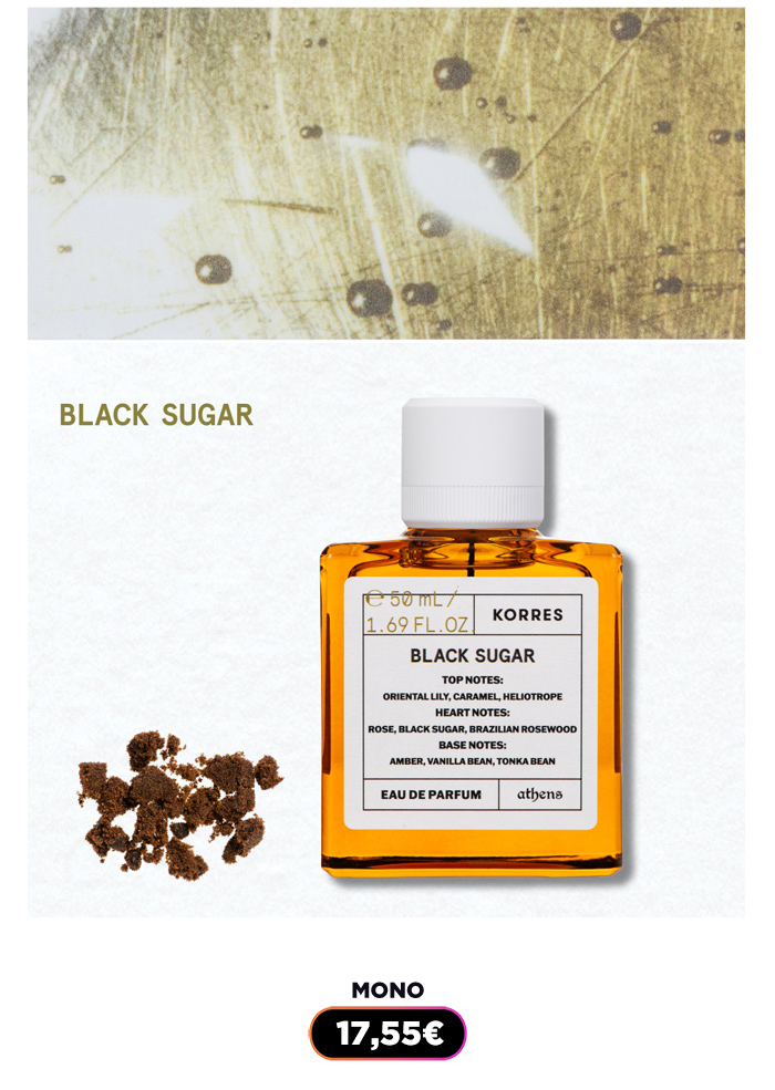 Amber glass bottle of Korres Black Sugar eau de parfum with white cap, visible label and scattered brown sugar granules beside bottle
